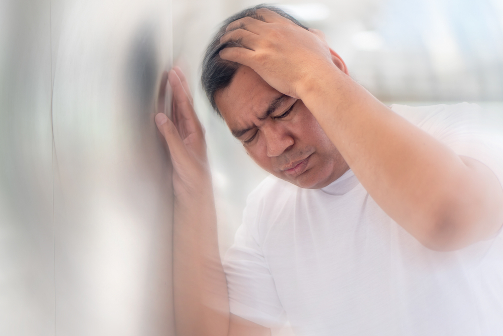 senior man suffering from vertigo headache; mental sickness concept for vertigo, dizziness, stress, depression, burnout, Alzheimer, brain cancer, Meniere disease, memory loss